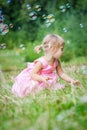 happy little girl chasing bubbles on nature in the park Royalty Free Stock Photo