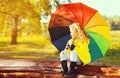 Happy little girl child with colorful umbrella in sunny autumn park Royalty Free Stock Photo