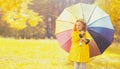 Happy little girl child with colorful umbrella in sunny autumn park Royalty Free Stock Photo