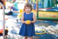 Happy little girl child in colourful plastic balls pool.