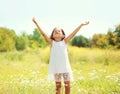 Happy little girl child enjoying sunny summer day and having fun