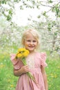 Happy Little Girl Child Holding Flowers Under the Apple Trees Royalty Free Stock Photo