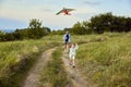 Happy little girl, child running with kite on trail in field. Spending time with parents outdoors on warm summer day Royalty Free Stock Photo