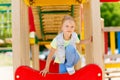 Happy little girl climbing on children playground Royalty Free Stock Photo