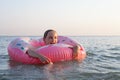 Happy little girl with colorful inflatable ring in sea water Royalty Free Stock Photo