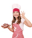 Little girl cook with cherry pie and ok hand sign