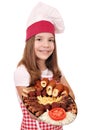 Little girl cook with mixed grilled meat and salad on plate