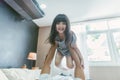 Happy little girl daughter playing with father while ride dad back and dad lying on the bed at home. Royalty Free Stock Photo