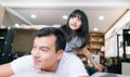 Happy little girl daughter playing with father while ride dad back and dad lying on the bed at home. Royalty Free Stock Photo