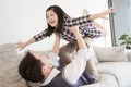 Happy little girl daughter playing with father while ride dad back and dad lying on the bed at home Royalty Free Stock Photo