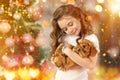 Happy little girl and dog beside Christmas tree. New year 2018. Holiday concept, Christmas, New year background. Royalty Free Stock Photo