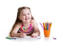 Happy little girl drawing with felt-tip pen in Royalty Free Stock Photo