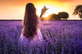 Happy little girl with dress enjoying lavender field with bouquet of flowers Royalty Free Stock Photo