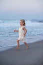 Happy little girl running and jumping at beach Royalty Free Stock Photo