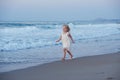 Happy little girl running and jumping at beach Royalty Free Stock Photo