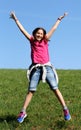 Little girl jumps on the lawn Royalty Free Stock Photo