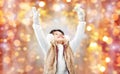 Happy little girl in earmuffs over holidays lights Royalty Free Stock Photo