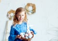Happy little girl in Easter with a basket of eggs Royalty Free Stock Photo