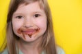 Happy little girl eating chocolate dirty face Royalty Free Stock Photo