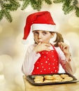 Happy little girl eating Christmas cookies Royalty Free Stock Photo