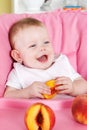 Happy little girl eating fruit Royalty Free Stock Photo