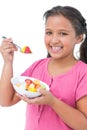 Happy little girl eating fruit salad Royalty Free Stock Photo