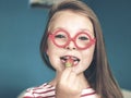 Happy little girl eating strawberries at home Royalty Free Stock Photo