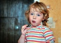 Happy little girl eats sweets Royalty Free Stock Photo