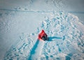 Happy little girl enjoy snow ride, winter kids activities Royalty Free Stock Photo