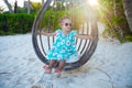 Happy little girl enjoy swing on white sandy Royalty Free Stock Photo