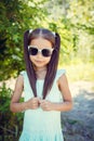 Happy little girl enjoying sunny day in the park. Wearing sun glasses Royalty Free Stock Photo