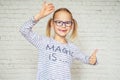 Happy little girl in eyeglasses with lost baby tooth and toothless mouth Royalty Free Stock Photo