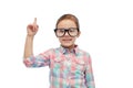 Happy little girl in eyeglasses pointing finger up Royalty Free Stock Photo