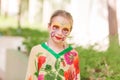 Happy little girl with face art paint in the park. Royalty Free Stock Photo