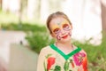 Happy little girl with face art paint in the park. Royalty Free Stock Photo