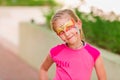 Happy little girl with face art paint in the park. Royalty Free Stock Photo