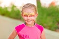 Happy little girl with face art paint in the park. Royalty Free Stock Photo