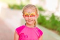 Happy little girl with face art paint in the park. Royalty Free Stock Photo