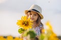 Happy little girl on the field of sunflowers in summer. beautiful little girl in sunflowers Royalty Free Stock Photo