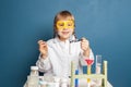 Happy little girl with flasks for chemistry. Science and education concept Royalty Free Stock Photo