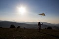 Happy little girl flying a kite on a hill of mountain Zlatibor, Serbia. Royalty Free Stock Photo