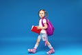 Happy little girl with glasses goes to school for the first time Royalty Free Stock Photo