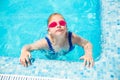 Happy little girl in goggles playing in swimming pool Beach resort, summer vacation, travel and tourism concept Royalty Free Stock Photo