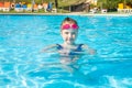 Happy little girl in goggles playing in swimming pool Beach resort, summer vacation, travel and tourism concept Royalty Free Stock Photo