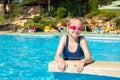 Happy little girl in goggles playing in swimming pool Beach resort, summer vacation, travel and tourism concept Royalty Free Stock Photo