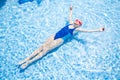 Happy little girl in goggles swim in swimming pool View from above Royalty Free Stock Photo