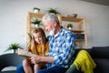 Happy little girl with grandfather reading story book at home Royalty Free Stock Photo