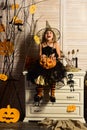 Happy little girl with halloween pumpkin. Wicked little witch. Girl happy smiling on halloween. Prettiest pumpkin in the