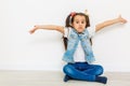 happy little girl with hands raised on white background Royalty Free Stock Photo