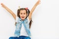 happy little girl with hands raised on white background Royalty Free Stock Photo